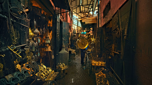 Rear view of people standing at illuminated market stall, morocco