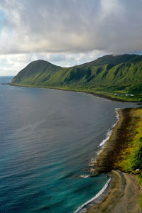 Scenic view of sea and mountains against sky