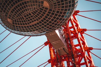 Low angle view of ferris wheel against blue sky