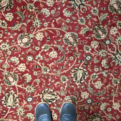 Low section of person standing on carpet