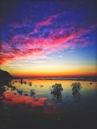 Scenic view of lake against romantic sky at sunset