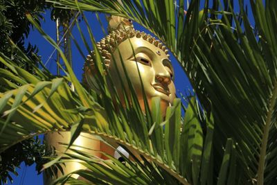 Low angle view of statue against trees