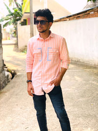 Portrait of young man standing on street