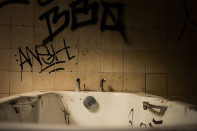 Graffiti on wall in bathroom