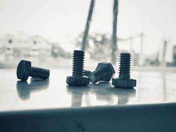 Close-up of metallic bolts and nuts stack on table