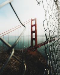 Close-up of suspension bridge in city