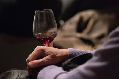 Close-up of hand holding wineglass