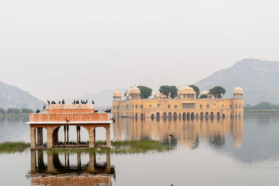 Built structure in lake against sky