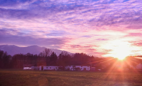 Scenic view of field against sky during sunset