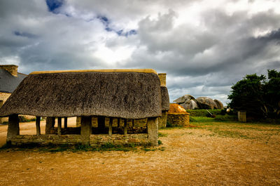 Built structure on field against sky