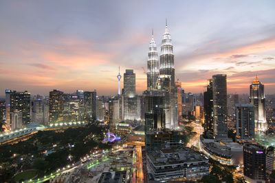 Illuminated cityscape against sky at night