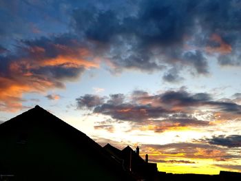 Low angle view of silhouette buildings against sky during sunset