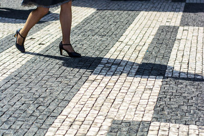 Low section of woman in high heels