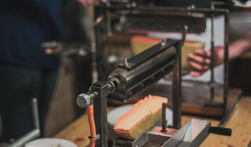 Close-up of man working at machine