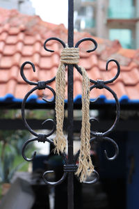 Close-up of chain hanging from metal grate