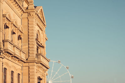 Low angle view of buildings against clear blue sky