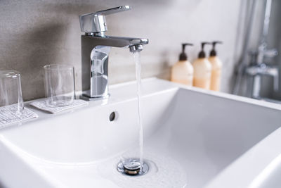 Close-up of water falling from faucet in bathroom