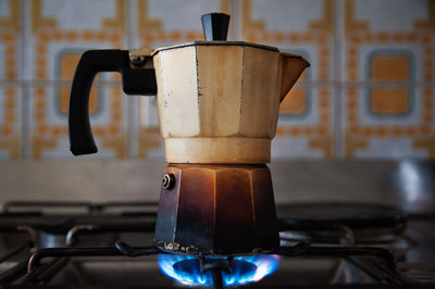 Close-up of coffee maker on stove in kitchen