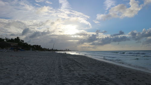 Scenic view of beach against sky during sunset