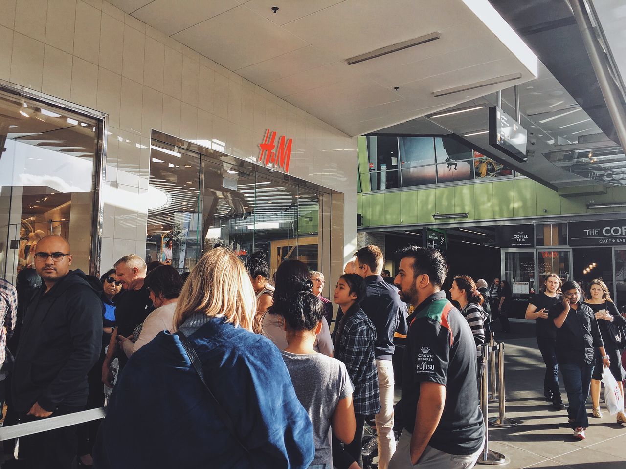 indoors, large group of people, men, standing, person, group of people, waiting, modern, rush hour, retail, crowd, party - social event, young adult