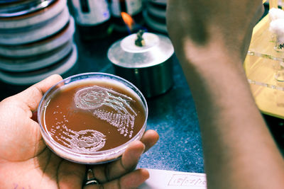 Close-up of hand holding drink