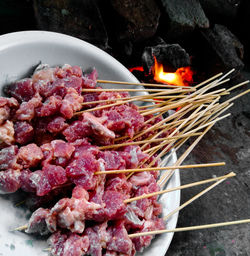 High angle view of meat on barbecue grill