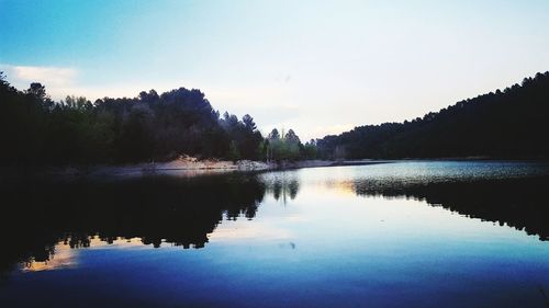 Scenic view of lake against sky at sunset