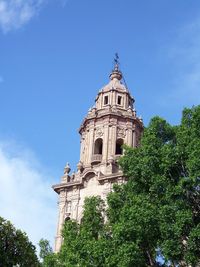 Low angle view of bell tower against blue sky