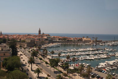 High angle view of townscape by sea against clear sky