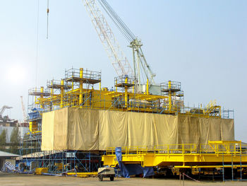 Yellow construction site against sky