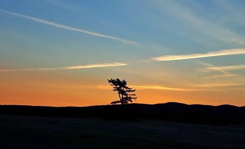 Silhouette landscape against sky during sunset