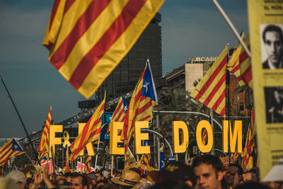 People on street against buildings in city