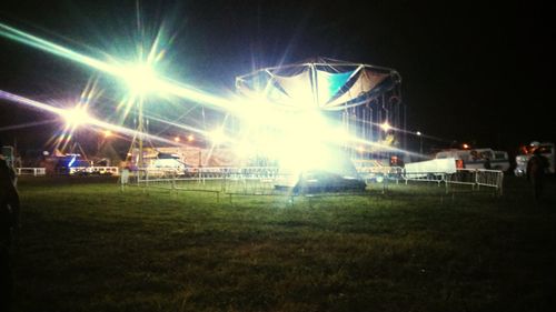 Illuminated built structure against sky at night