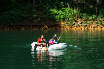 People in boat on lake