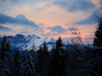 Scenic view of snowcapped mountains against sky during sunset