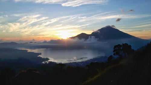 Scenic view of silhouette mountains against sky during sunset