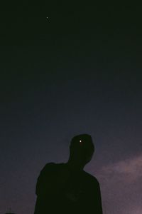 Low angle view of silhouette person against sky