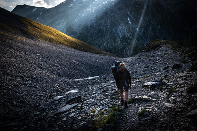 Full length of hiker walking on rocks