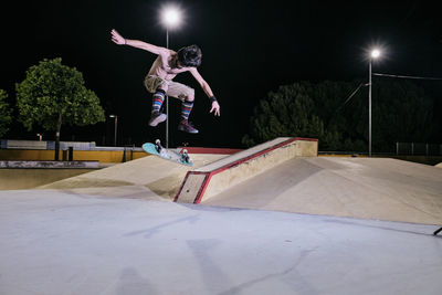 Young white man jumping on his skateboard