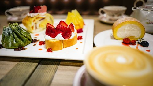 Close-up of swiss roll desert with strawberry on plate