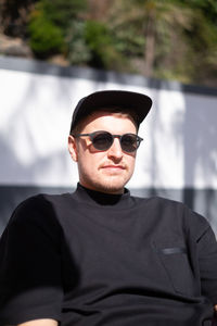 Portrait of man wearing sunglasses standing outdoors