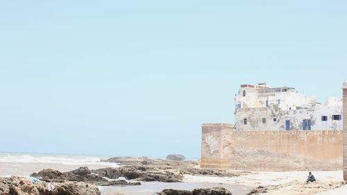 Built structure on beach against clear sky