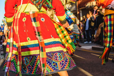 Midsection of people with traditional clothing on road