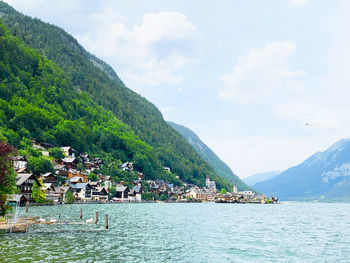 Scenic view of sea and mountains against sky