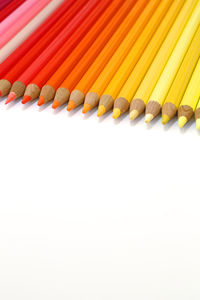 Close-up of multi colored pencils against white background