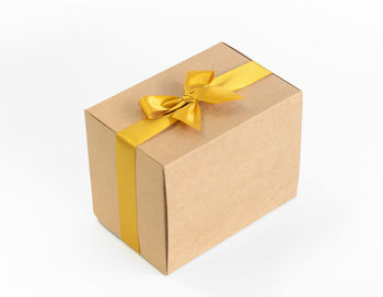 Close-up of yellow paper box on white background