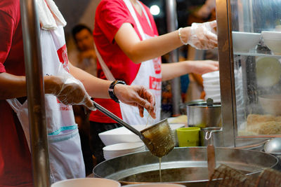 Group of people working in kitchen