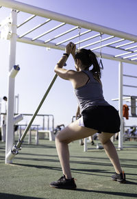 Rear view of woman exercising outdoors