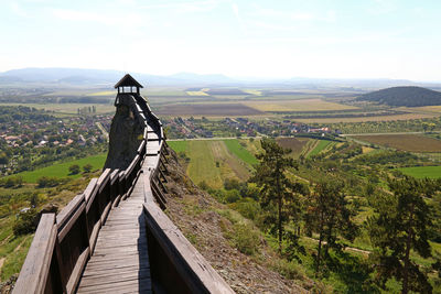 Narrow walkway along landscape with mountain in background