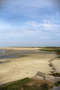 View of beach against cloudy sky